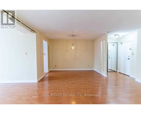 Empty room with wooden floors and white walls.