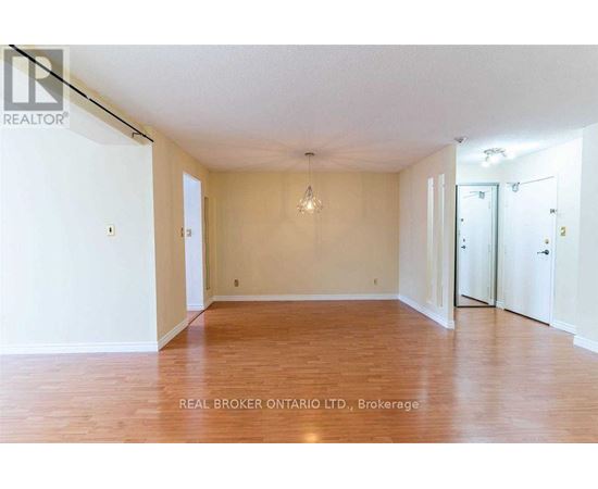 Empty room with wooden floors and white walls.