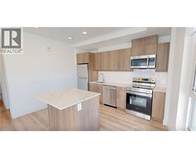 A modern kitchen with wooden cabinets and stainless steel appliances.