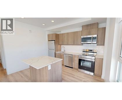 A modern kitchen with wooden cabinets and stainless steel appliances.
