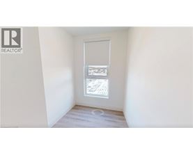 A room with a window showing a view of a building.