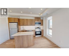A modern kitchen with wooden cabinets and appliances.