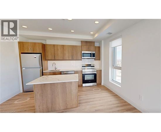 A modern kitchen with wooden cabinets and appliances.