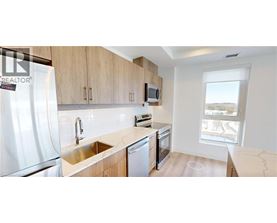 A kitchen with a sink, stove, and refrigerator.