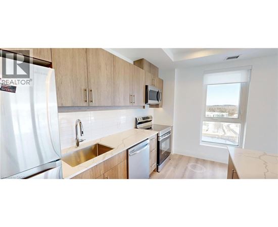 A kitchen with a sink, stove, and refrigerator.