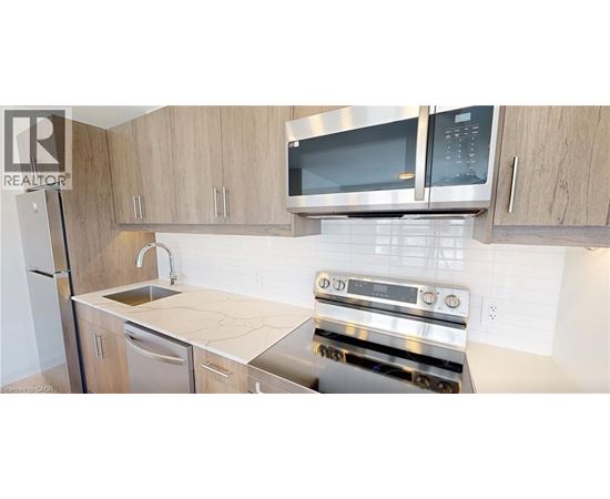 A kitchen with a stove top oven and microwave above it.
