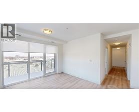 A spacious room with a view of the city through large windows.