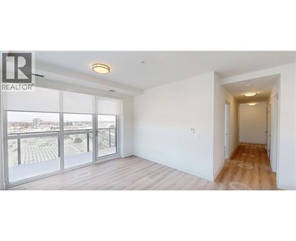 A spacious room with a view of the city through large windows.