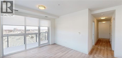 A spacious room with a view of the city through large windows.