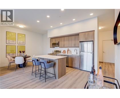 A modern kitchen with a dining table and chairs.