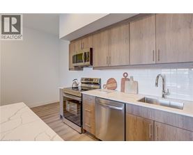 A modern kitchen with wooden cabinets and stainless steel appliances.