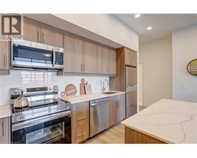 A modern kitchen with wooden cabinets and stainless steel appliances.