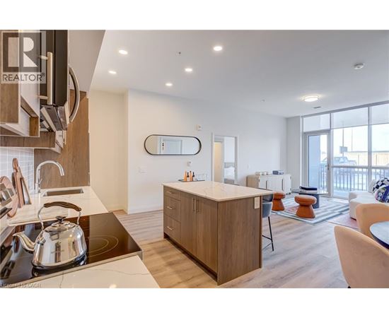 A modern kitchen with a large island and a dining area.