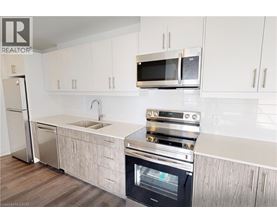 A modern kitchen with a stainless steel oven and microwave.