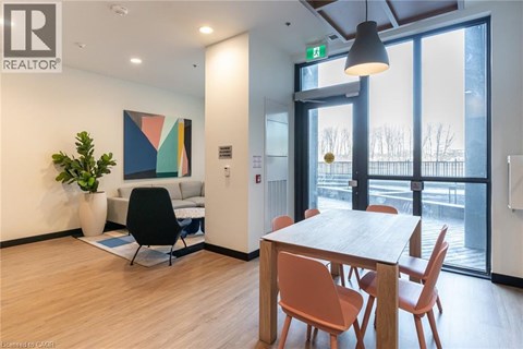 A modern dining room with a wooden table and chairs.