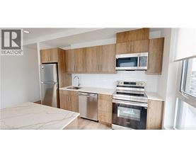A modern kitchen with wooden cabinets and stainless steel appliances.
