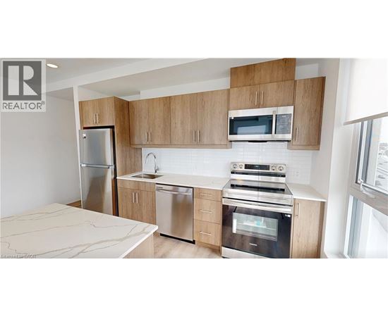 A modern kitchen with wooden cabinets and stainless steel appliances.