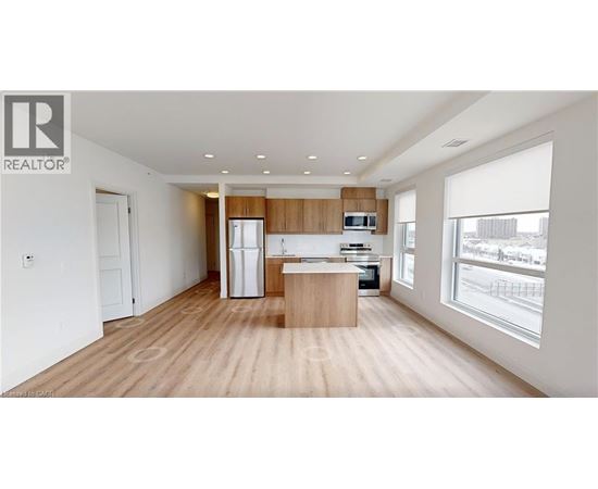 A modern kitchen with wooden floors and white walls.