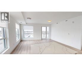 A spacious, empty room with a large window overlooking a cityscape.