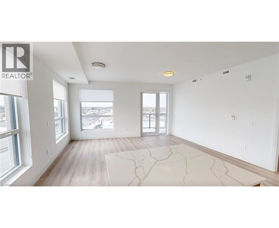 A spacious, empty room with a large window overlooking a cityscape.