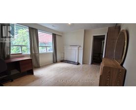 A room with a white cabinet and a window with curtains.