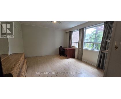 A room with a desk and a chair in it.
