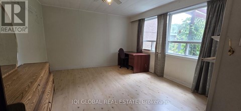A room with a desk and a chair in it.