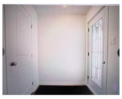 A white door is on the left and a white door with a window is on the right.