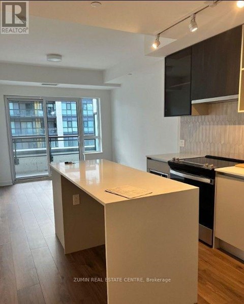A kitchen with a white countertop and a stove top oven.