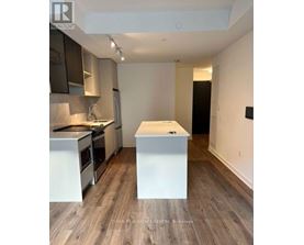 A kitchen with a white island in the middle of the room.