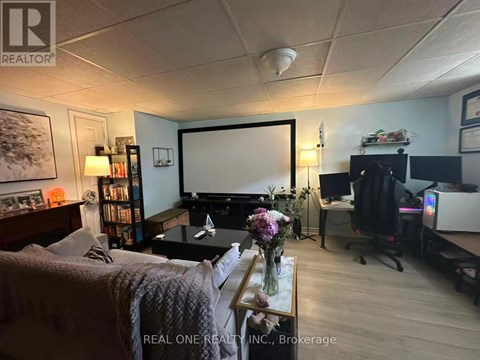 A living room with a couch, a coffee table, a television, and a bookshelf.