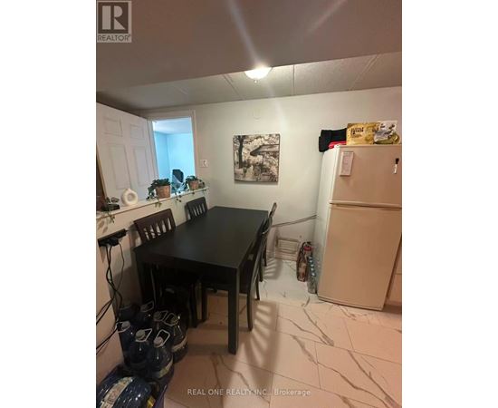 A dining room with a table and chairs.