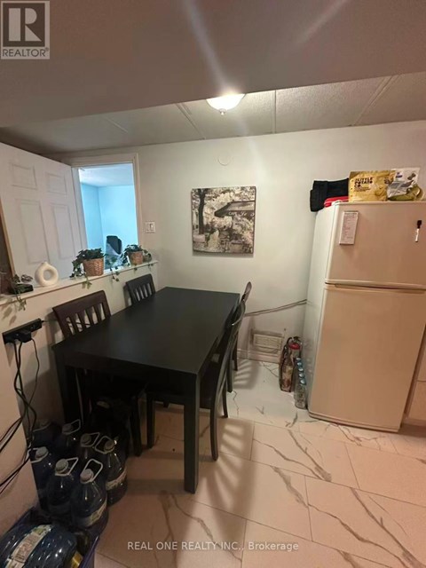 A dining room with a table and chairs.