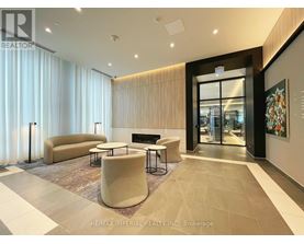 A modern living room with a fireplace and a large painting on the wall.