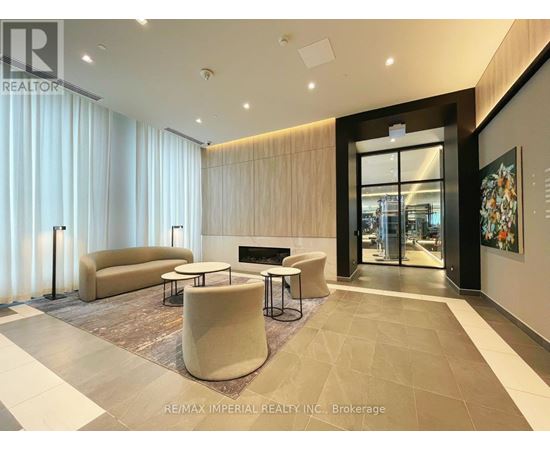 A modern living room with a fireplace and a large painting on the wall.