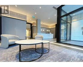 A modern office space with a glass wall and a white table in the center.