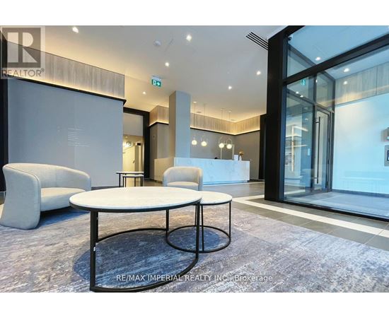 A modern office space with a glass wall and a white table in the center.