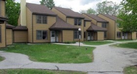 A building with brown siding and a white door.