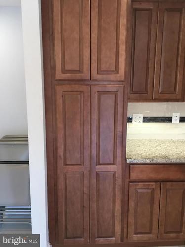 A brown wooden door with a white frame.
