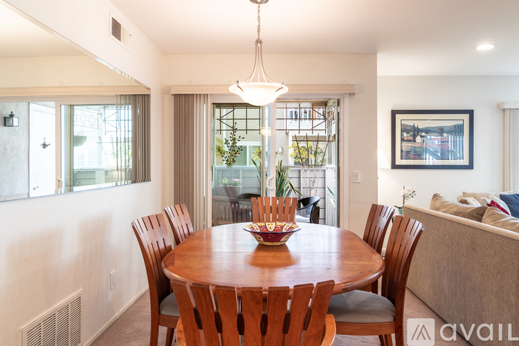 A dining room with a wooden table and chairs.