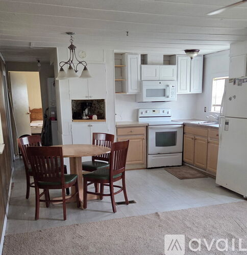 A kitchen with a table and chairs in the middle of the room.