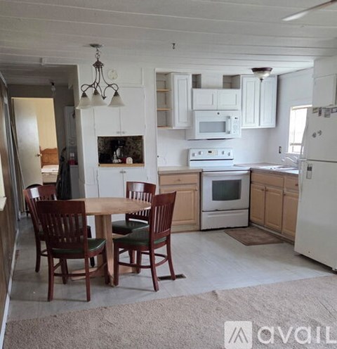 A kitchen with a table and chairs in the middle of the room.