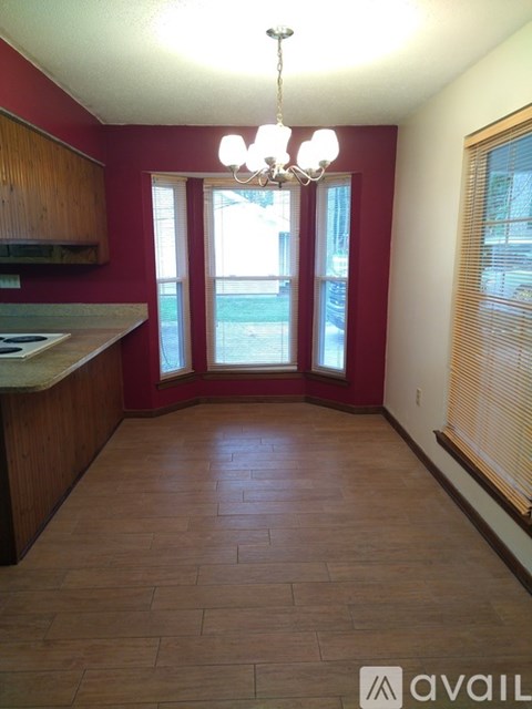 A kitchen with a chandelier and a window.