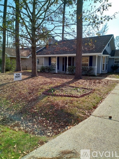A house with a for rent sign in front of it.