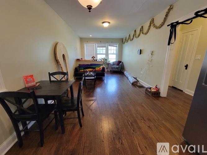 A dining room with a wooden table and chairs.
