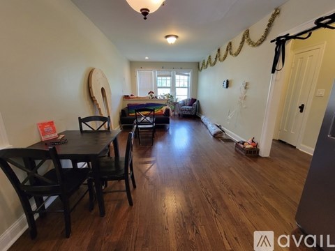 A dining room with a wooden table and chairs.
