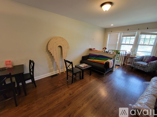 A living room with a couch, chairs, and a fireplace.