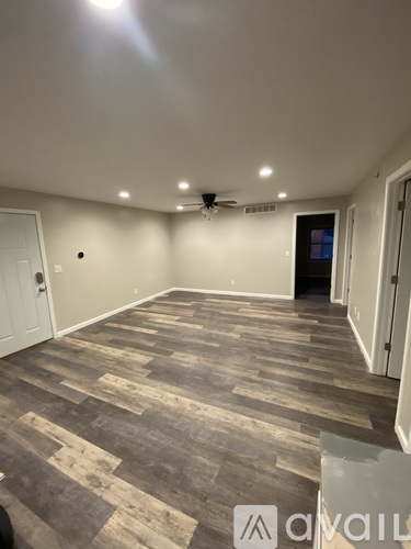 A room with wooden flooring and a ceiling fan.