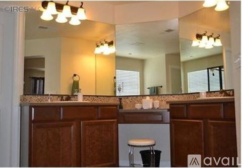A kitchen with a counter and a stool.