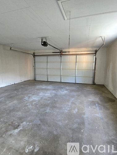 A spacious garage with a concrete floor and a white ceiling.